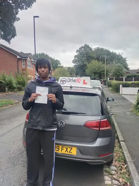 Learner who just passed, standing with a DriveSQ car
